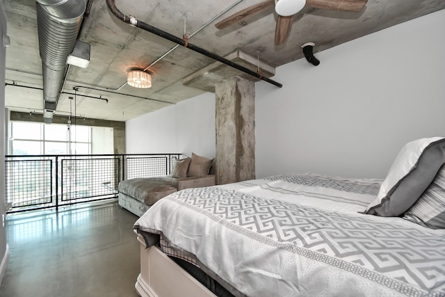 bedroom with ceiling fan and concrete flooring