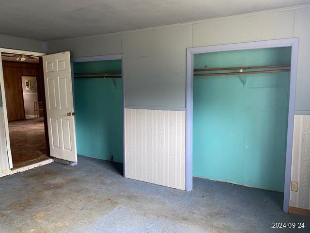 unfurnished bedroom with multiple closets