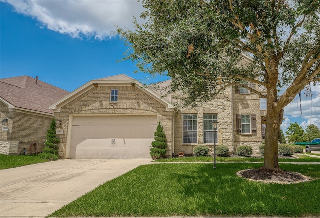 view of front of home with a garage and a front lawn