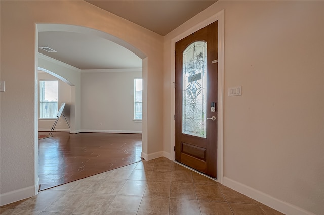 foyer entrance featuring light hardwood / wood-style floors and crown molding