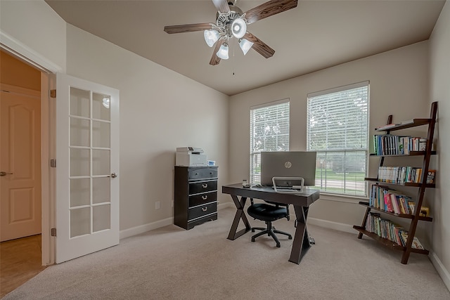 office space with ceiling fan, light colored carpet, and french doors