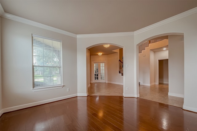 empty room with crown molding and hardwood / wood-style floors