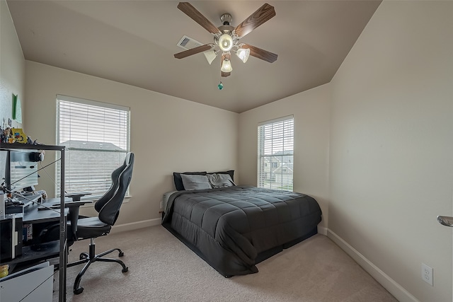 bedroom featuring light carpet and ceiling fan