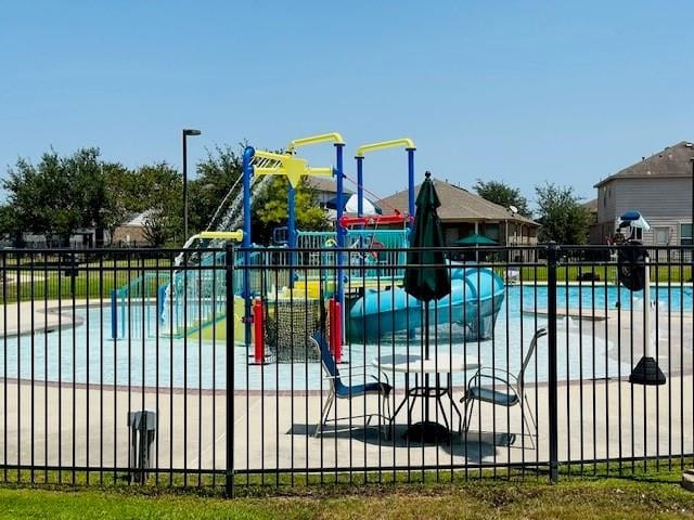 view of playground featuring a community pool