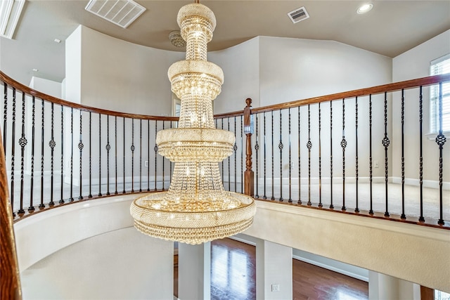 staircase featuring hardwood / wood-style flooring and a chandelier