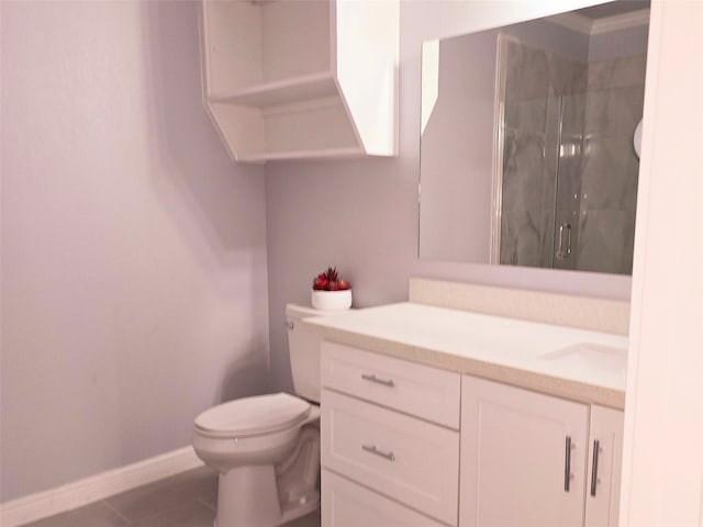 bathroom featuring tile patterned floors, toilet, a shower with door, and vanity