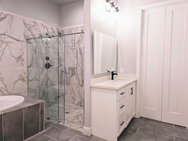 bathroom featuring independent shower and bath, vanity, and tile patterned floors