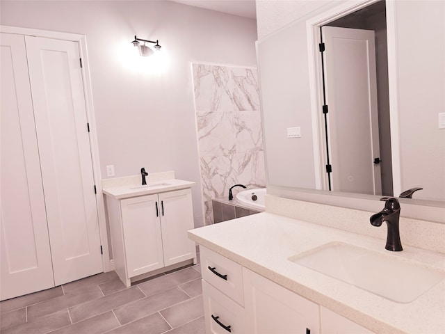 bathroom featuring vanity and a bath