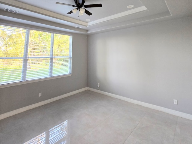 unfurnished room featuring ornamental molding, a tray ceiling, and ceiling fan