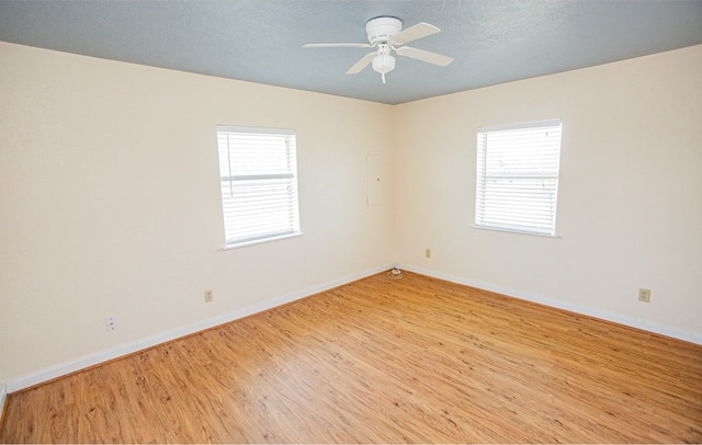 unfurnished room featuring light hardwood / wood-style floors, a textured ceiling, and ceiling fan