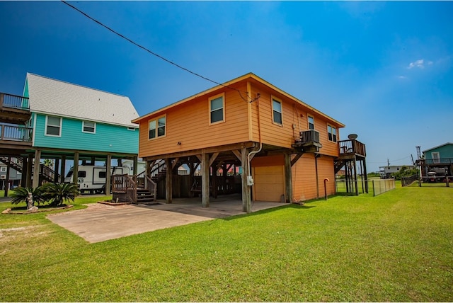 rear view of house with a garage, a lawn, and a carport