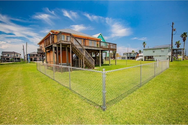 back of property with a deck and a lawn