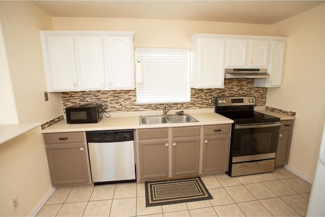 kitchen with decorative backsplash, sink, stainless steel appliances, light tile patterned floors, and white cabinetry