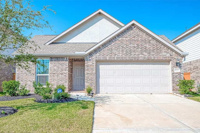 view of front of property with a garage and a front lawn