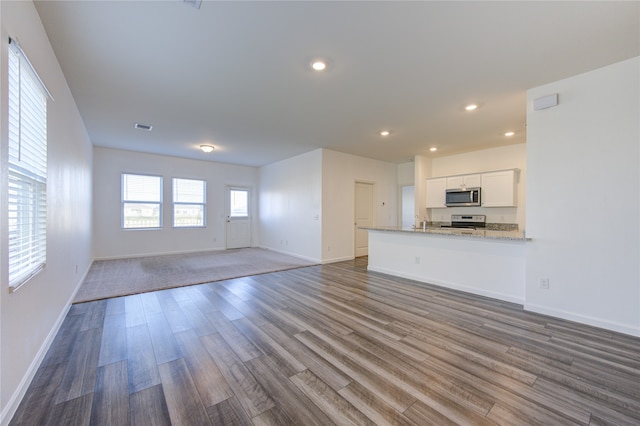 unfurnished living room with wood-type flooring