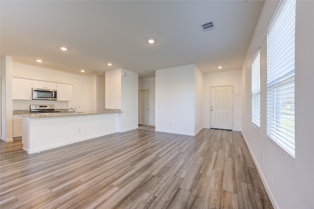 unfurnished living room featuring light wood-type flooring