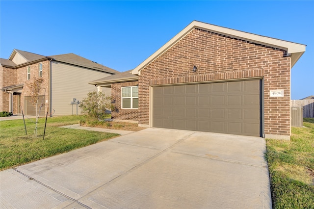 view of front of home featuring a garage and a front yard