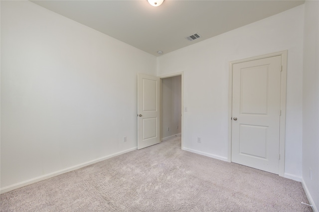 unfurnished room featuring light colored carpet