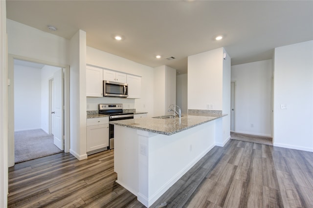 kitchen with sink, light hardwood / wood-style floors, kitchen peninsula, white cabinetry, and appliances with stainless steel finishes