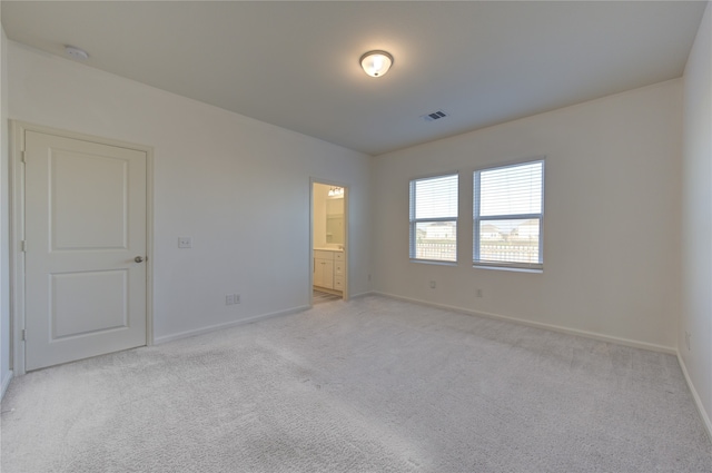 empty room featuring light colored carpet