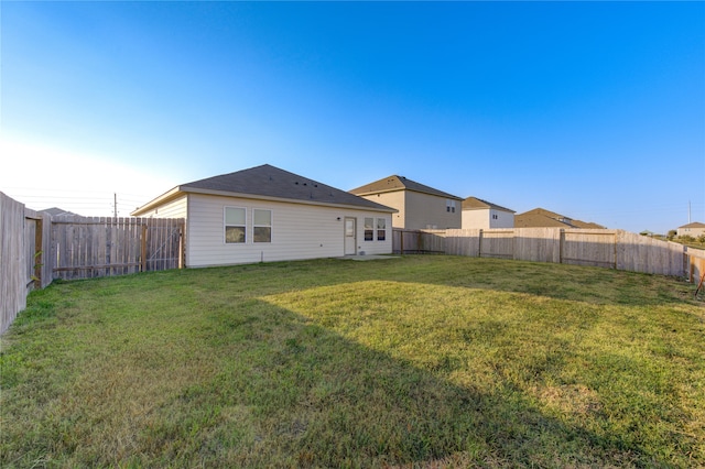 rear view of property featuring a yard