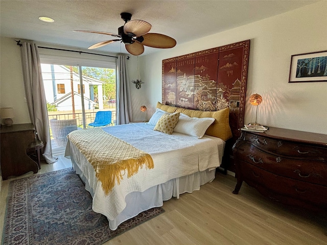 bedroom featuring access to outside, hardwood / wood-style floors, and ceiling fan