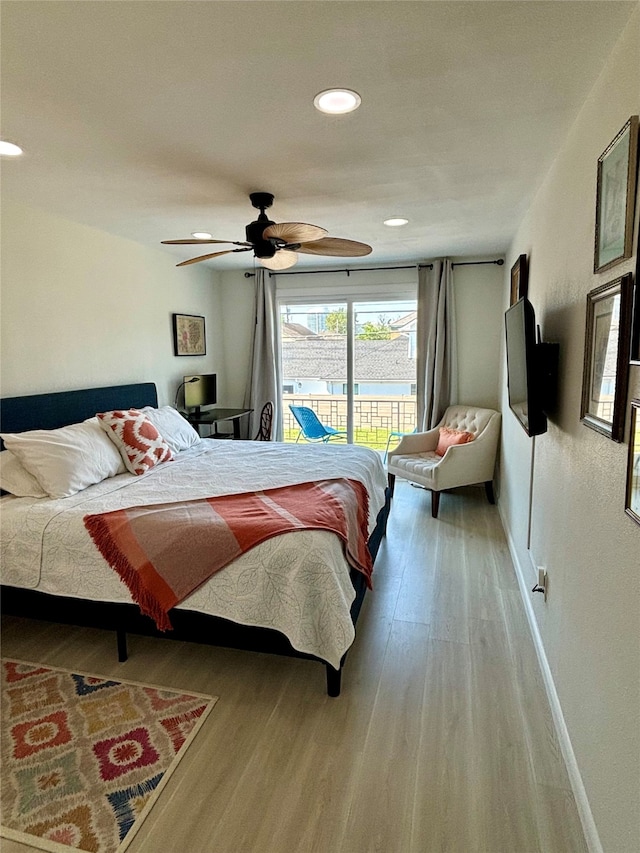 bedroom with ceiling fan, wood-type flooring, and access to outside