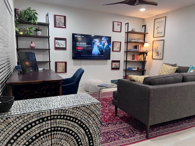 living room featuring ceiling fan and hardwood / wood-style flooring