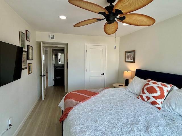 bedroom featuring ceiling fan, a closet, and light hardwood / wood-style floors