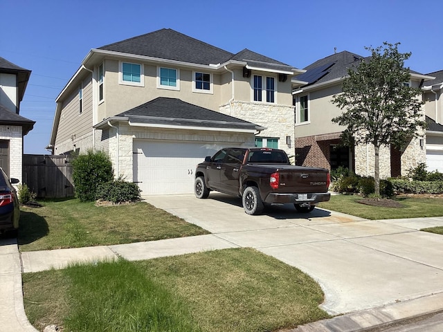 view of front of home with a front lawn and a garage