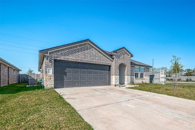 view of front of home with a front yard and a garage