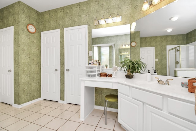 bathroom featuring tile patterned flooring, a shower with door, and vanity