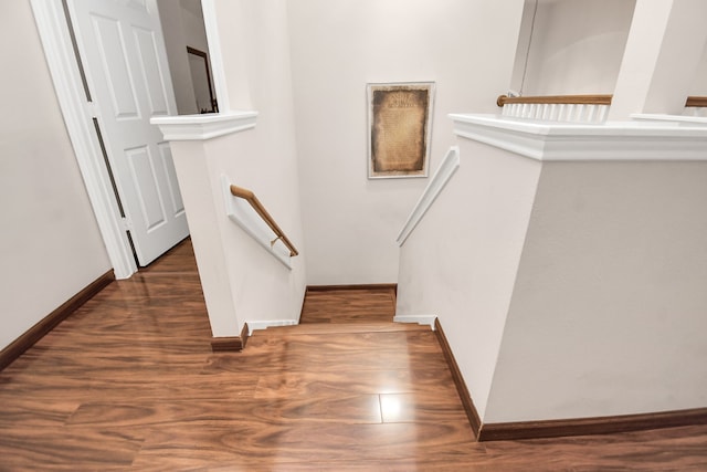 stairs featuring hardwood / wood-style floors