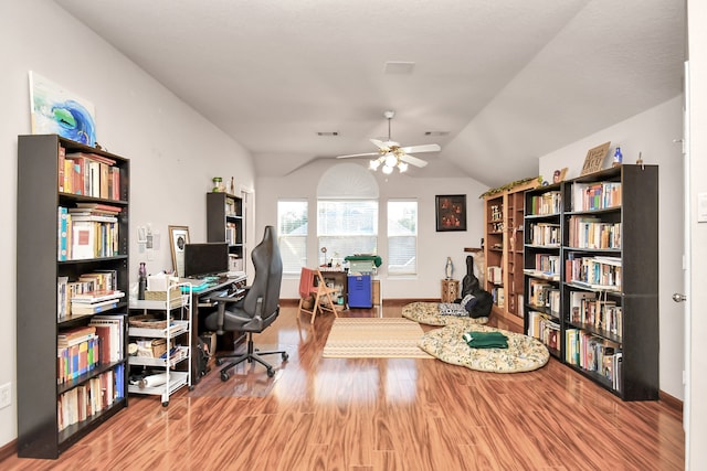 home office featuring hardwood / wood-style flooring, ceiling fan, and vaulted ceiling