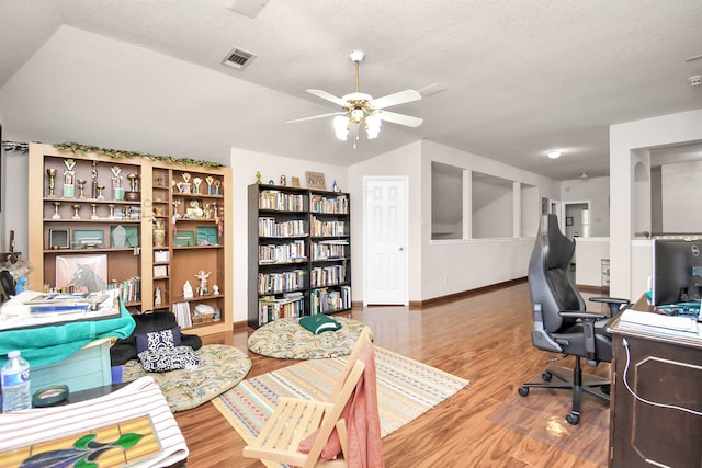 office featuring ceiling fan, hardwood / wood-style floors, and a textured ceiling