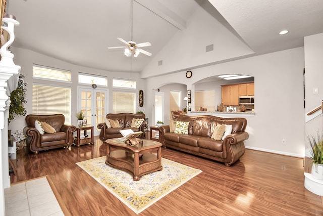 living room with beamed ceiling, high vaulted ceiling, ceiling fan, french doors, and dark hardwood / wood-style floors