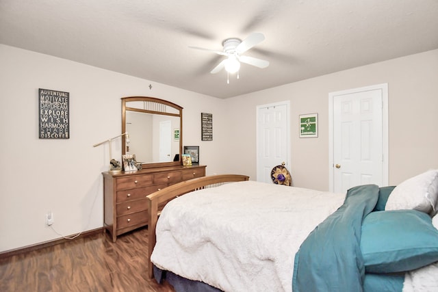 bedroom with ceiling fan and dark wood-type flooring