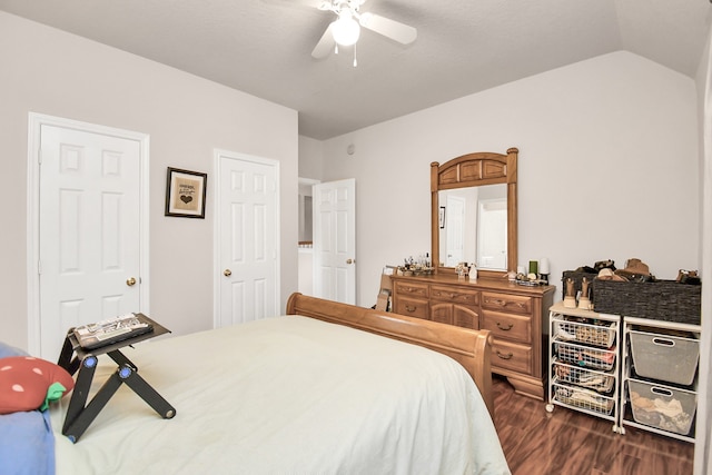 bedroom featuring dark wood-type flooring, lofted ceiling, and ceiling fan