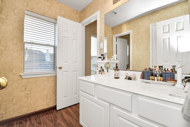 bathroom with hardwood / wood-style floors, a wealth of natural light, and vanity