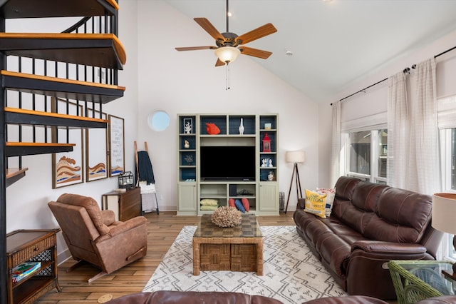 living room featuring ceiling fan, hardwood / wood-style flooring, and high vaulted ceiling