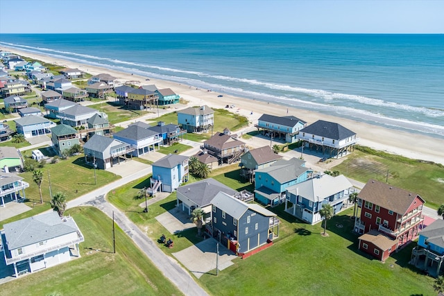 bird's eye view featuring a water view and a beach view