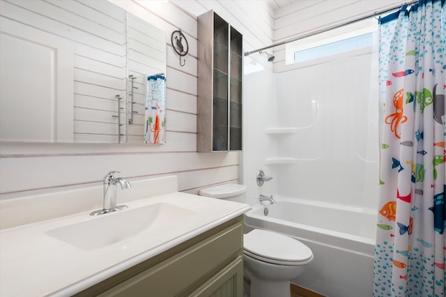 full bathroom with vanity, shower / tub combo, toilet, and wood walls