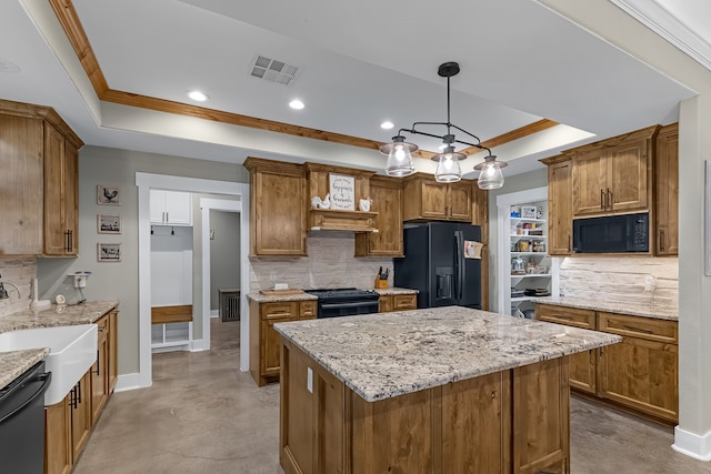 kitchen featuring black appliances, decorative light fixtures, a kitchen island, and backsplash