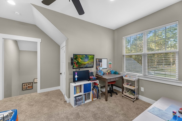 carpeted office space with vaulted ceiling and ceiling fan