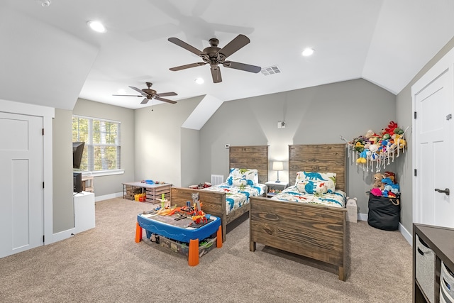 bedroom featuring light colored carpet, vaulted ceiling, and ceiling fan