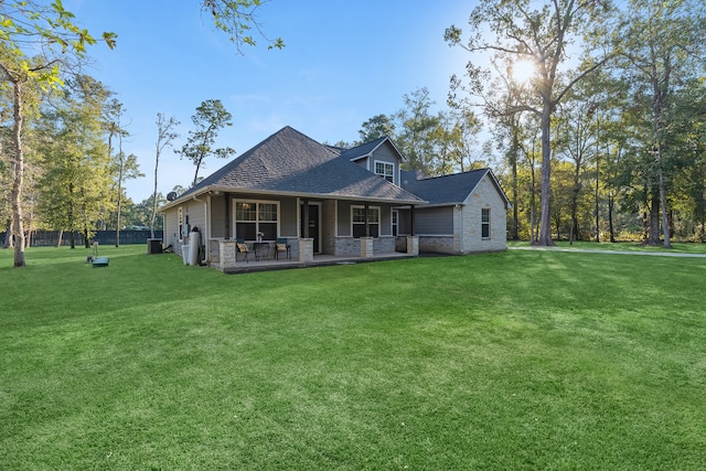 view of front of house with central AC unit and a front lawn