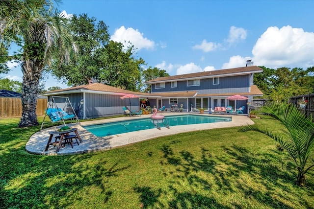 view of swimming pool featuring a yard and a patio