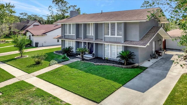 view of front of house featuring a front yard and a garage