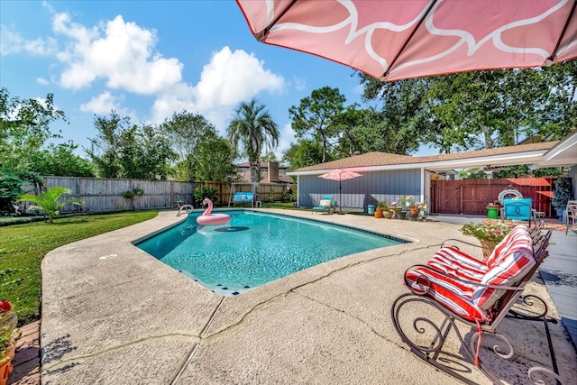 view of swimming pool featuring a yard and a patio