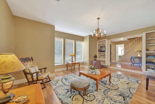 living room with a notable chandelier and light hardwood / wood-style flooring